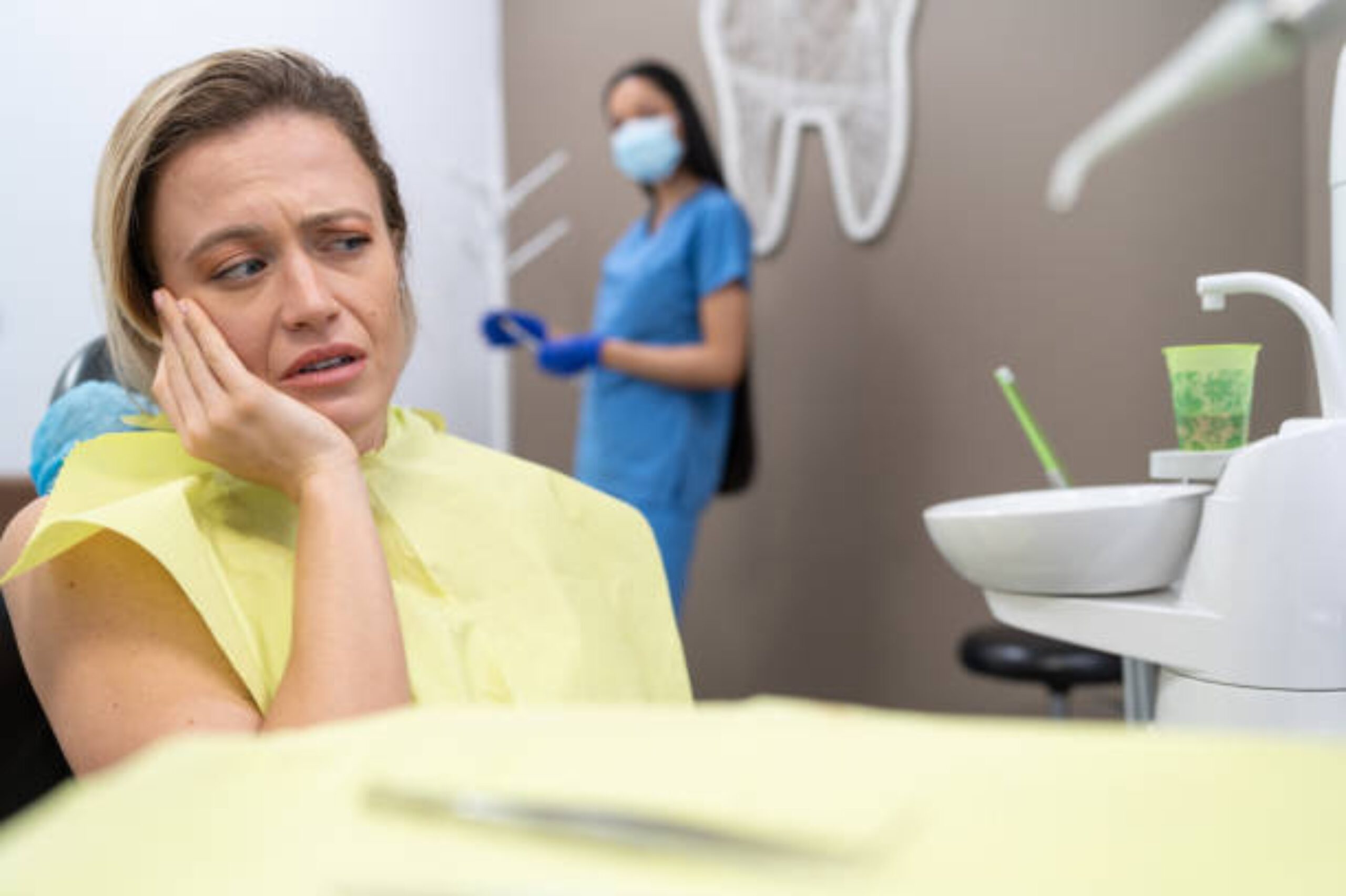 Emergency dentist in Vancouver examining patient with tooth pain